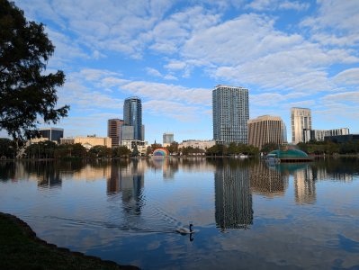 PXL_20241118_131936406 -- A faint morning moon emerges from the clouds over Lake Eola.jpg